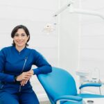 Smiling female dentist sitting in a modern clinic, ready for patients