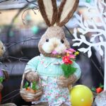 Adorable Easter bunny decoration with vibrant flowers and a carrot-filled basket.
