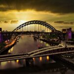 A captivating sunset view of the Tyne Bridge in Newcastle with vibrant reflections on the river.